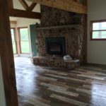 Rustic Living Room with Wood Tile and Stone Fireplace