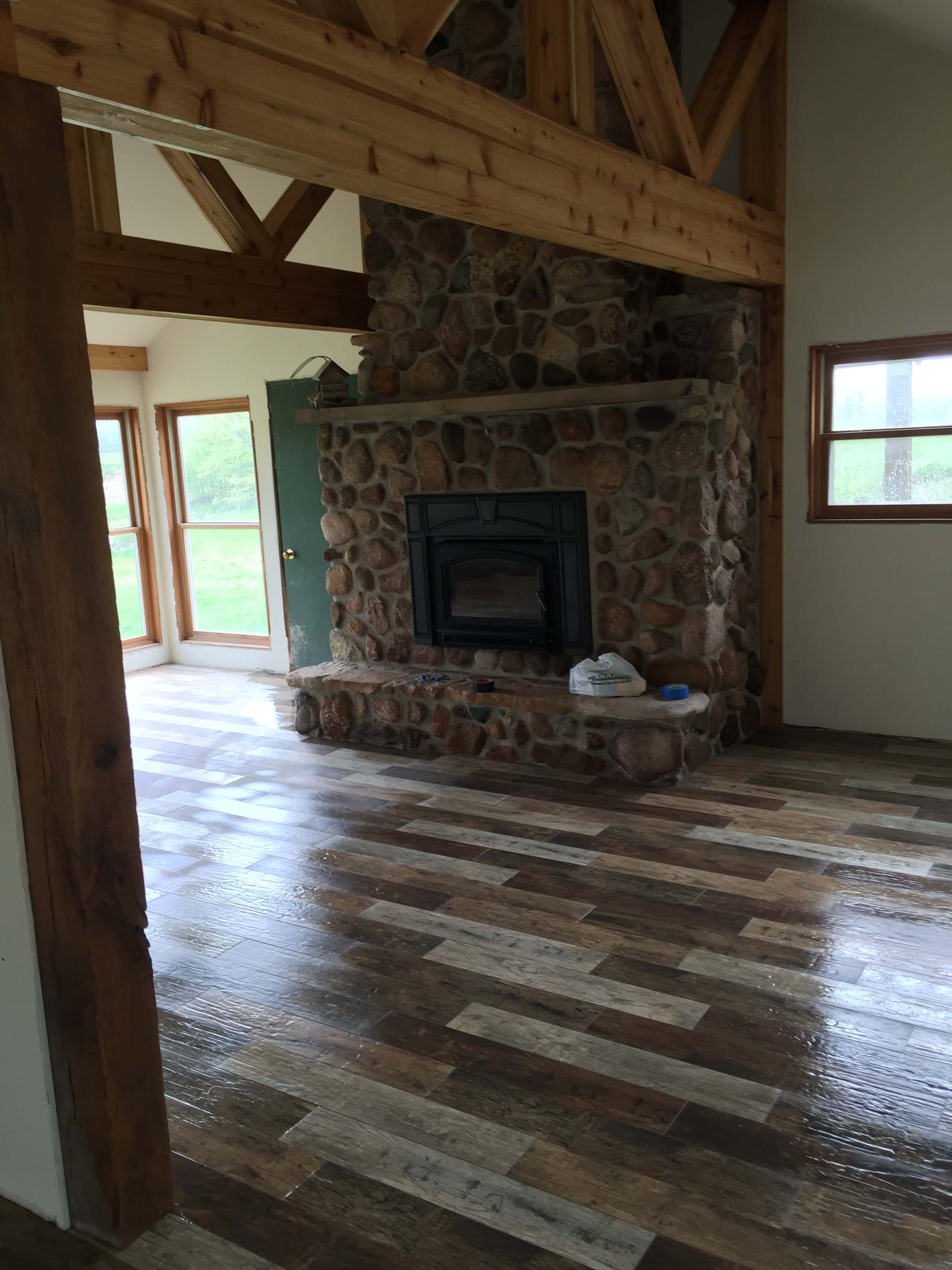 Rustic Living Room with Wood Tile and Stone Fireplace