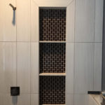 White Tile Shower with Black Shelves